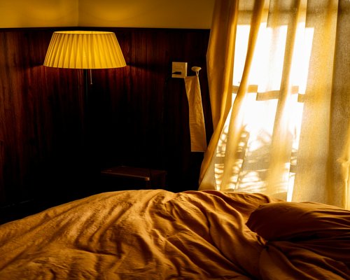 A peaceful, neatly arranged bedroom with soft, warm lighting suitable for deep rest